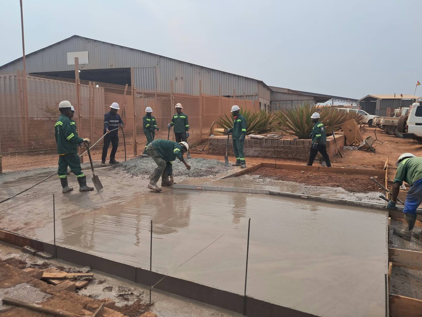 L'équipe Tali Engineers règle une dalle en béton fraîchement coulée à la règle